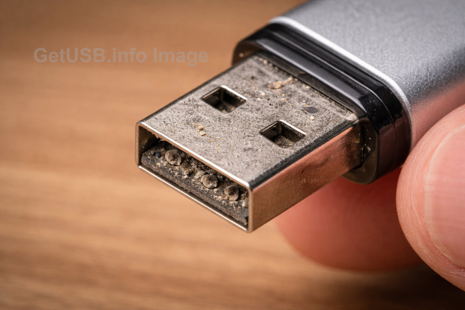Dirty USB port showing dust buildup that leads to intermittent charging and data errors