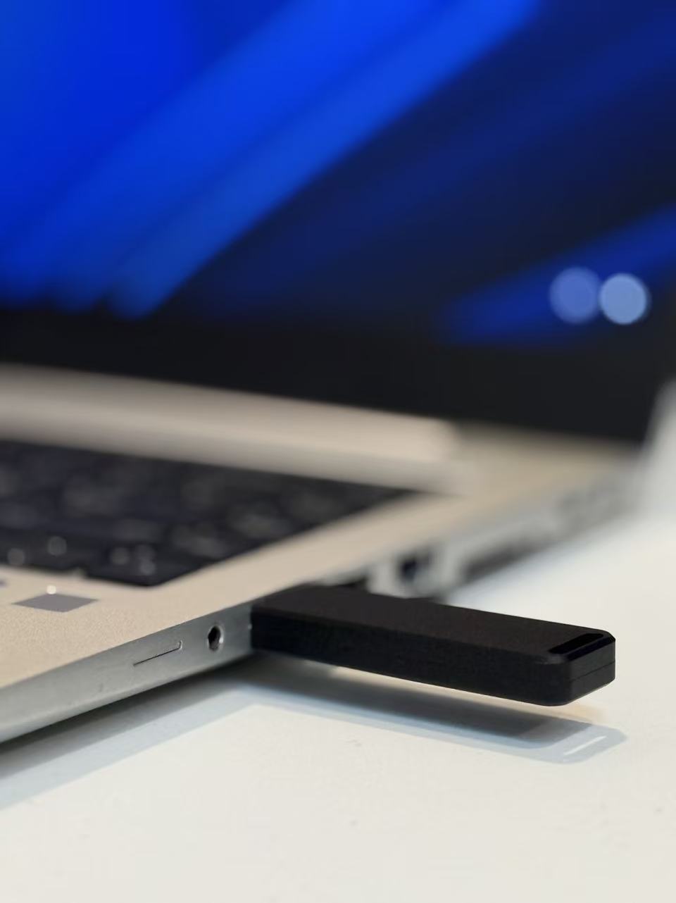 Two USB flash drives connected to a laptop, illustrating how similar devices can use different USB transport methods such as BOT and UASP